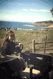 Jun Lee Cruzing in golf cart around the course
